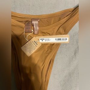 Skims cheeky Tinga bottoms in almond color